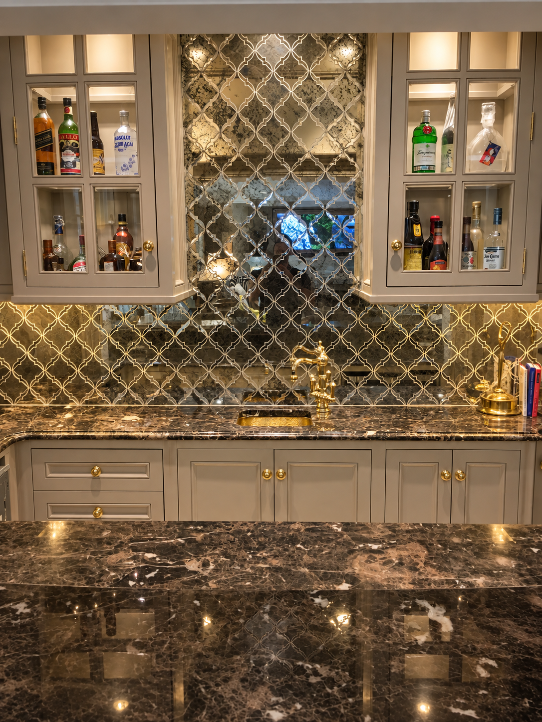 Custom bar with illuminated display cabinetry and marble finishes