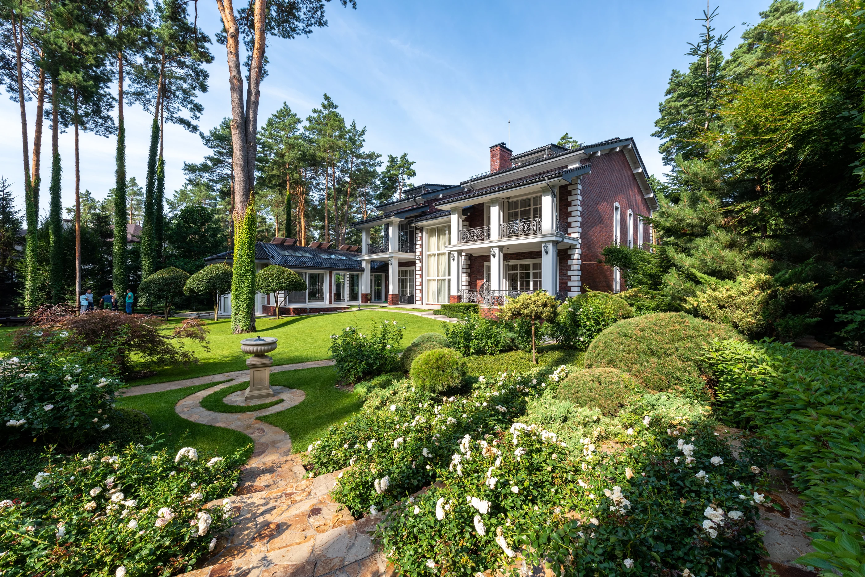 Traditional residential home surrounded by landscaped grounds